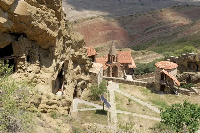 The Lavra of David from above: the red roofs of the courtyard and striped hills on the horizon