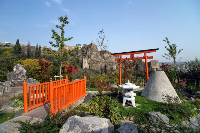 The Japanese garden: a little bridge, a torii and the walls of Narikala